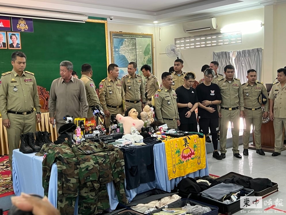 柬埔寨警方今（15日）下午在西哈努克省警察局召開記者會，網紅晚安小雞（左黑衣）、阿鬧（右黑衣）遭上銬現身。圖/取自柬中時報