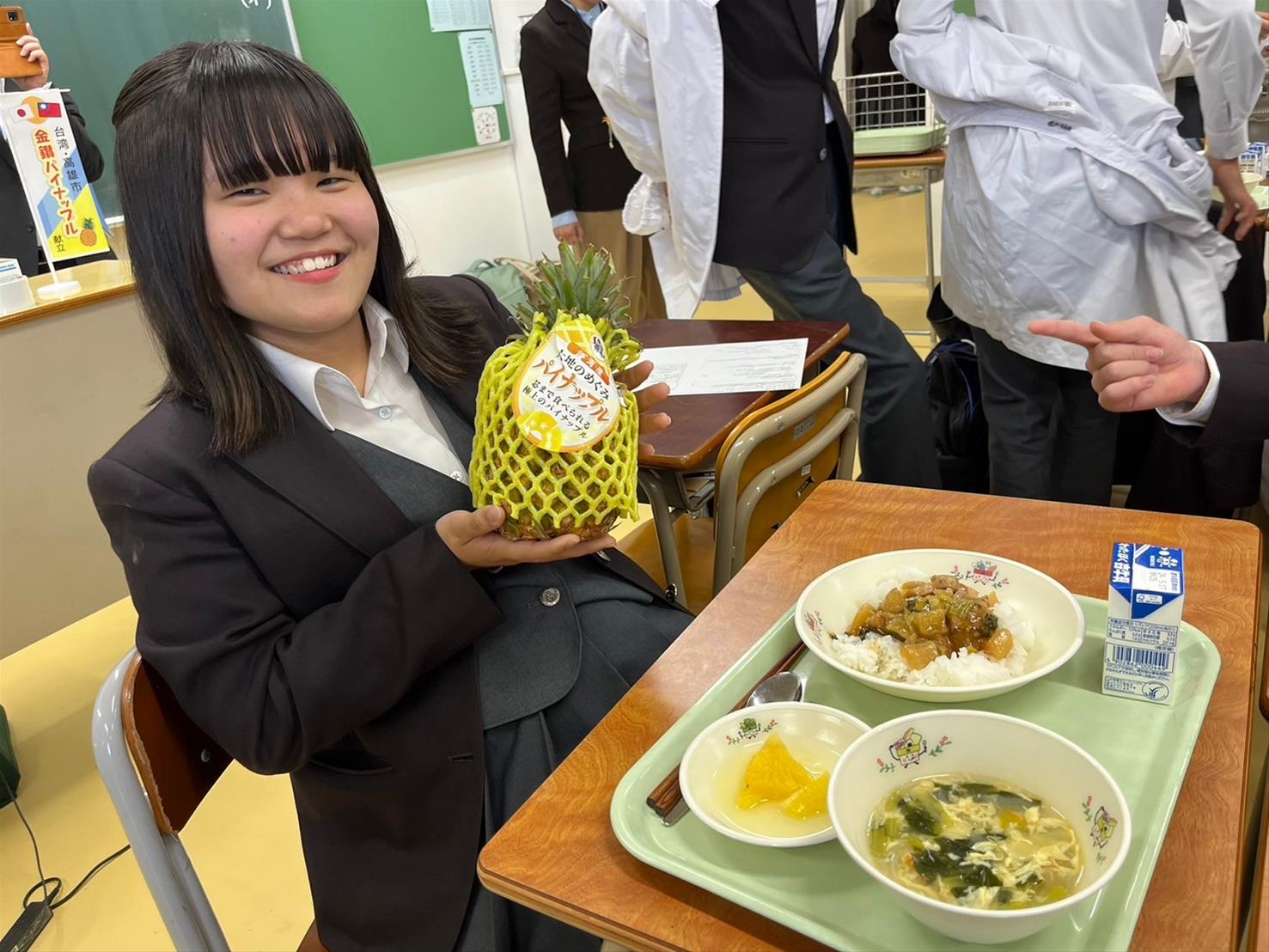 日本八王子市第四中學學生開心與台灣鳳梨合影。圖/取自高雄市政府網站