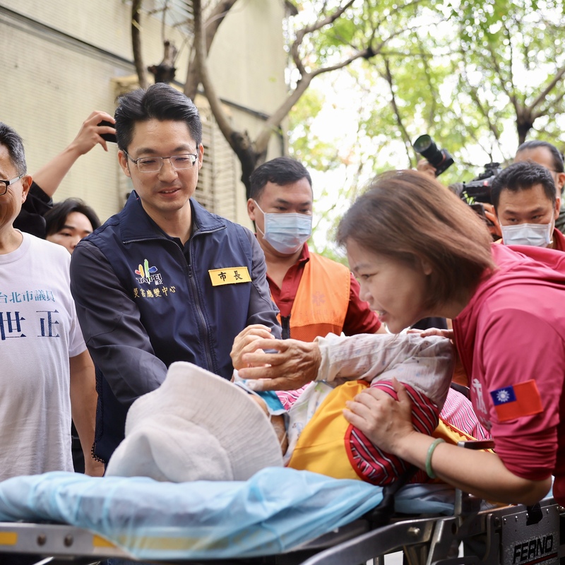 圖為台北市長蔣萬安25日協助身體不適的婦人就醫的畫面。圖/中央社