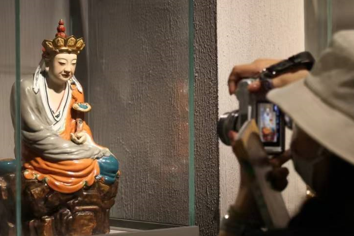 圖為遊客在博物館內參觀火出圈的「沉思羅漢」（被網友稱為「無語菩薩」）陶瓷雕塑。 圖/中新社記者劉佔昆攝